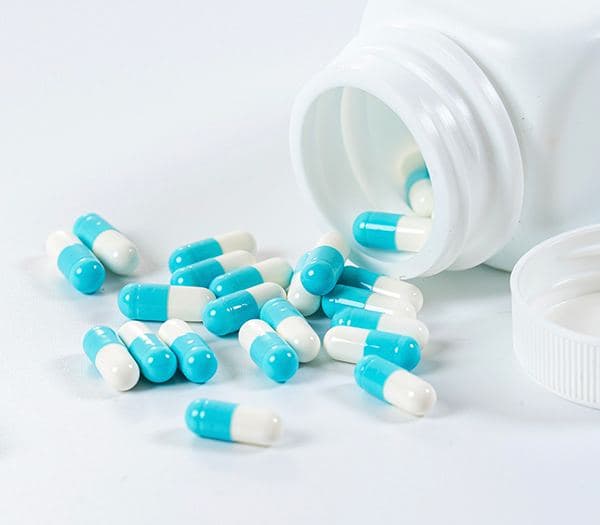 Allopathy pills falling from plastic bottle