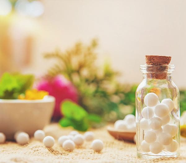 Homoeopathic pills in a glass bottle